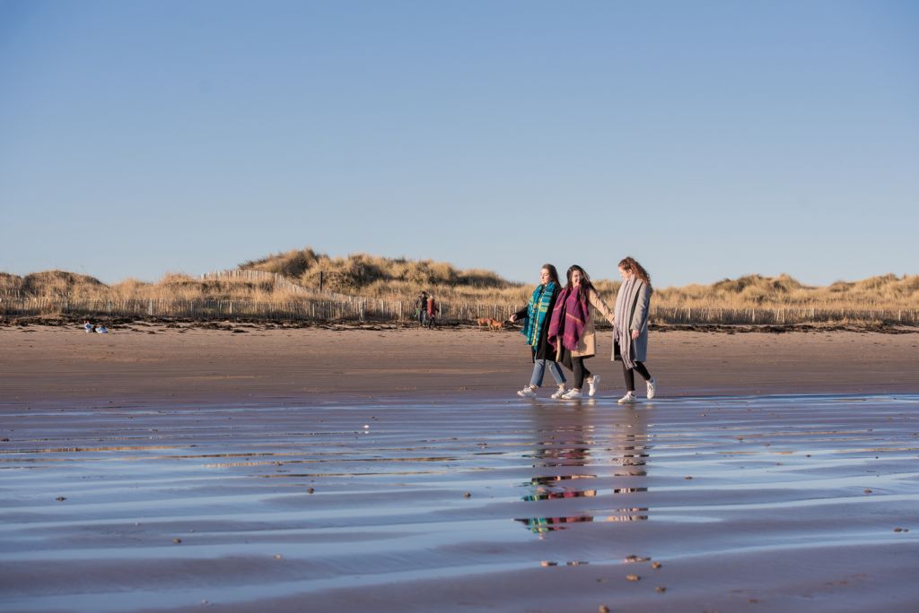 Students walking on the beach