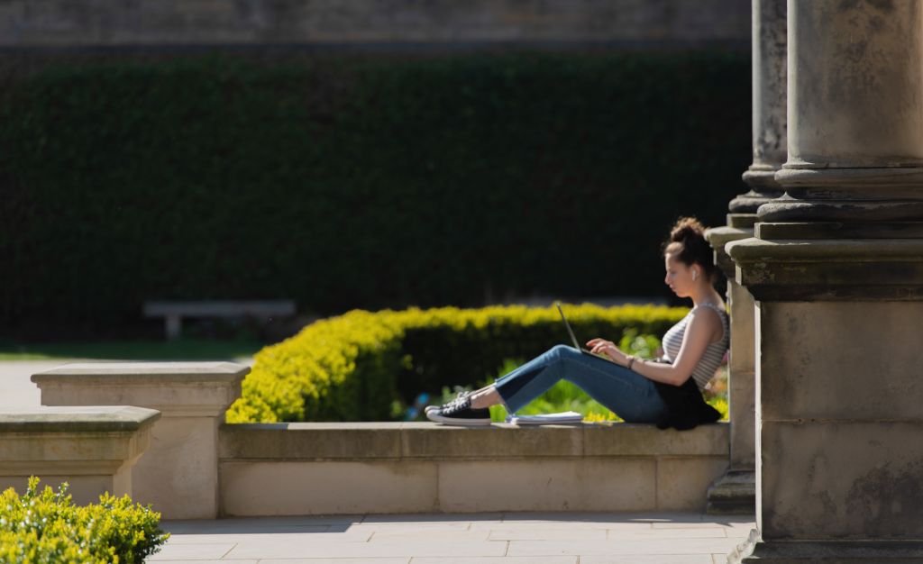 Student outside on her laptop